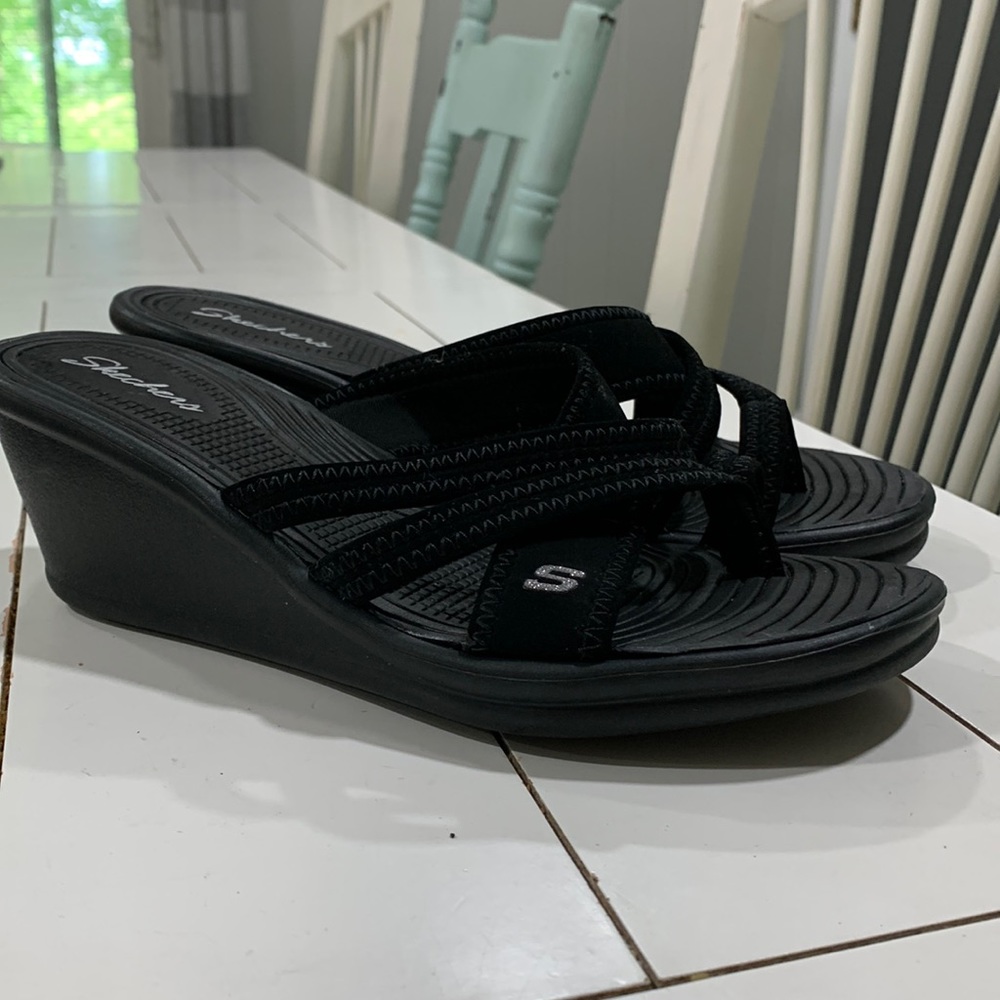 Woman’s black Sketchers wedge sandal